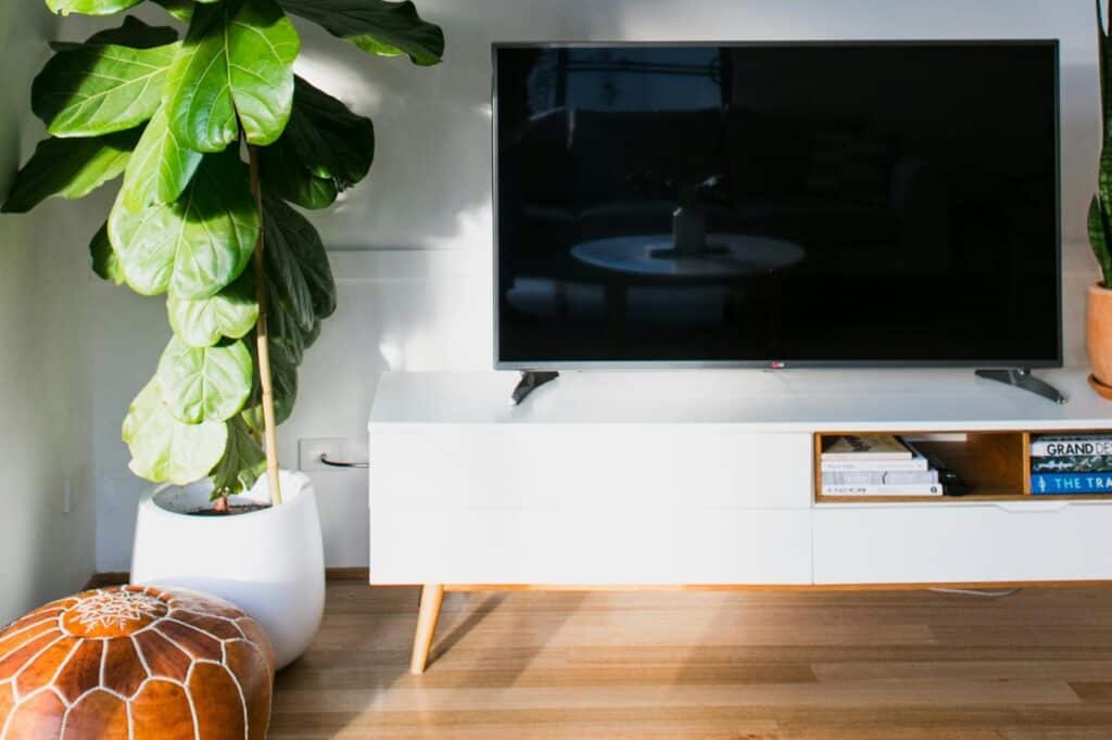 A smart TV on a white table in the living room